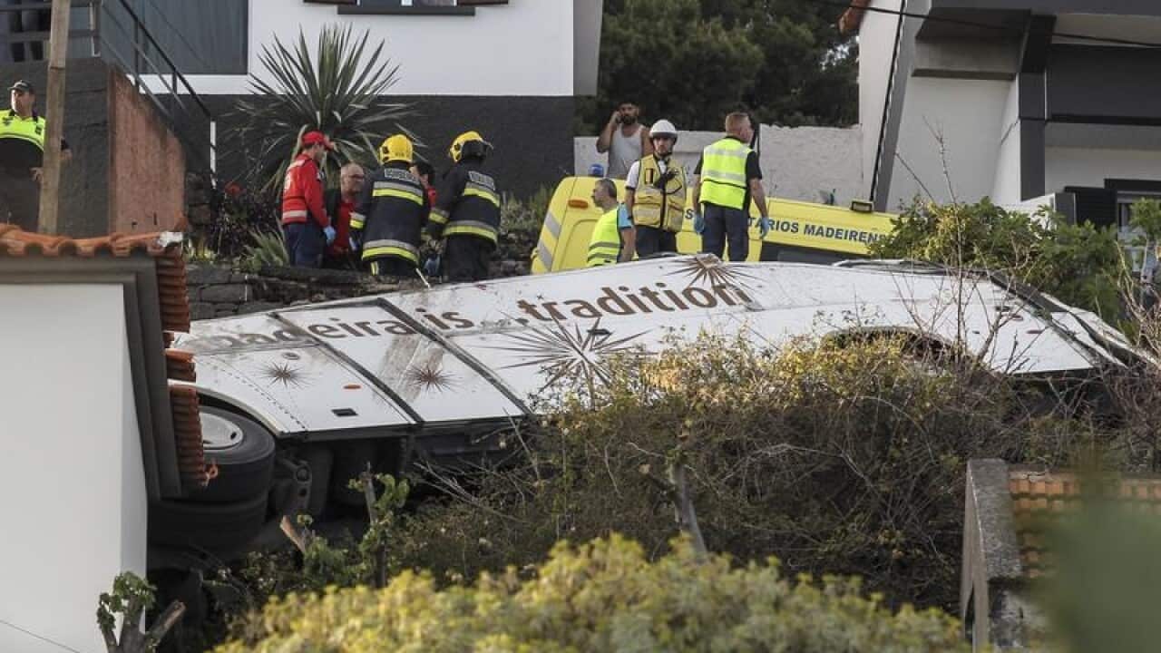 Emergency services inspect the scene of a tourist bus crash