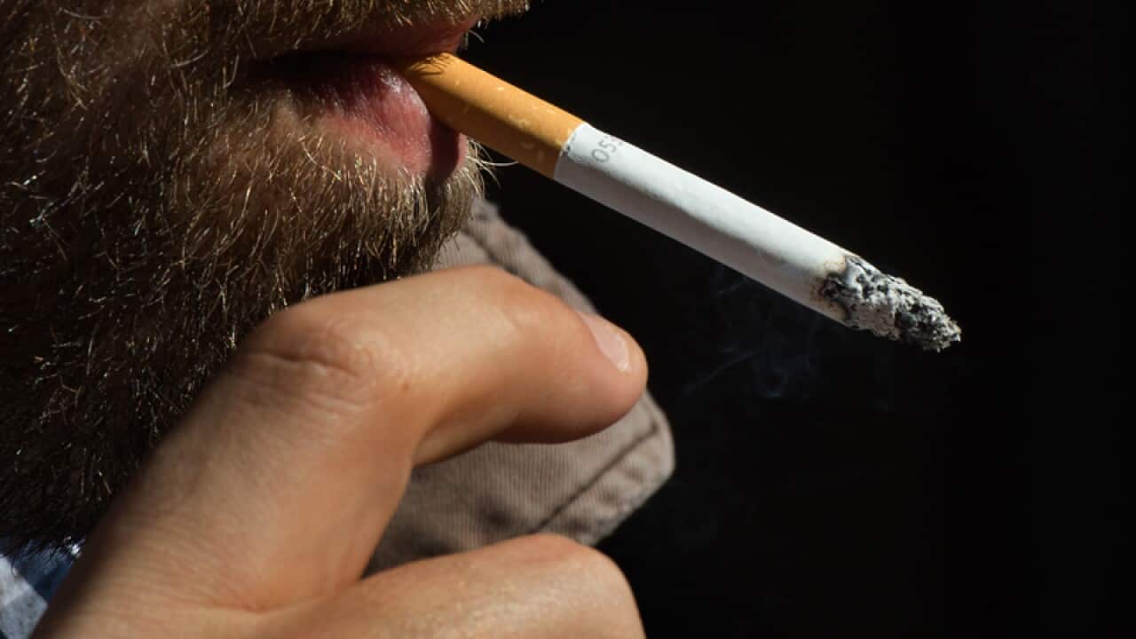 A person smokes a cigarette