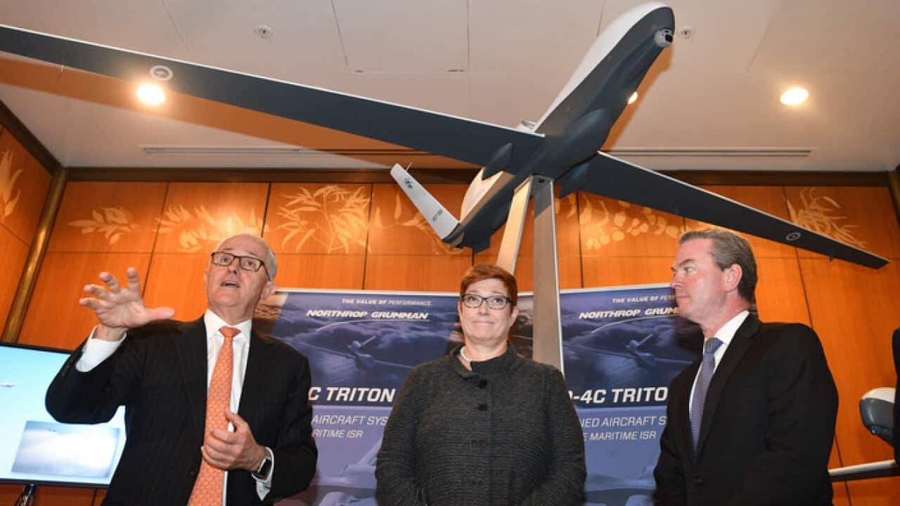 Prime Minister Malcolm Turnbull, Minister for Defence Marise Payne and Minister for Defence Industry Christopher Pyne with a replica of a MQ-4C Triton drone at Parliament House in Canberra.