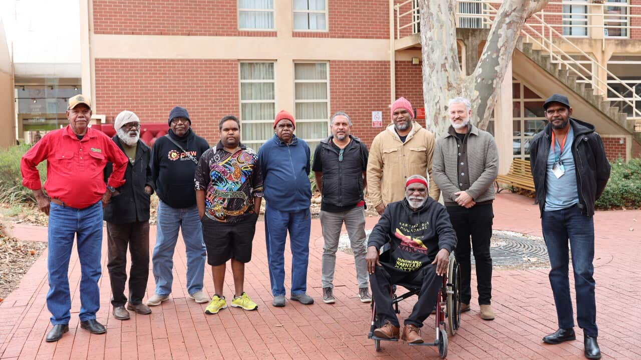 A supplied image obtained on 19 June 2022 shows a group of Warlpiri men who have collected sacred objects returned to Australia from the University of Virginia, at the South Australian Museum in Adelaide.