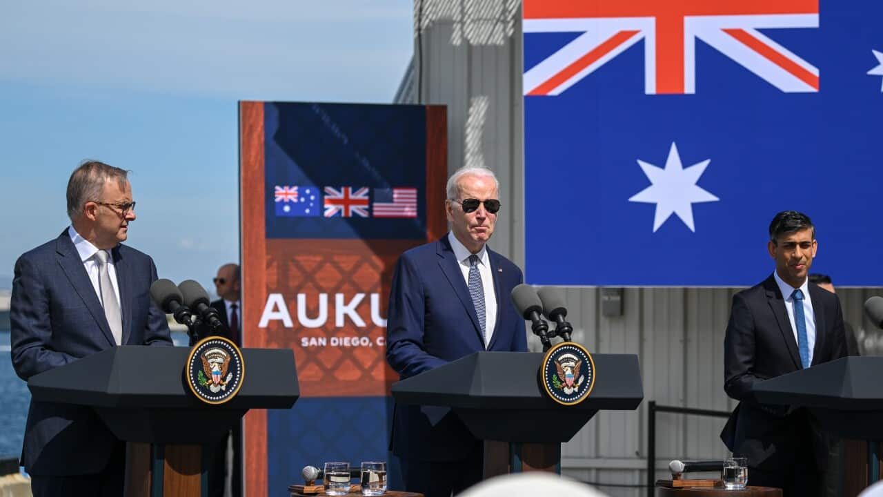 Joe Biden, Anthony Albanese and Rishi Sunak stand at podiums