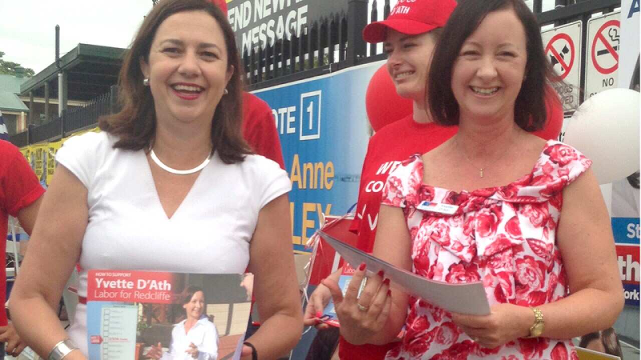 Yvette D'Ath (R) hands with Annastacia Palaszczuk