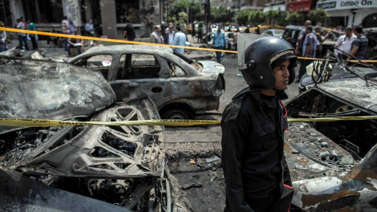 An Egyptian policeman stands guard at the site of a bombing that killed Egypt’s top prosecutor, Hisham Barakat, in Cairo, Egypt, Monday, June 29, 2015.