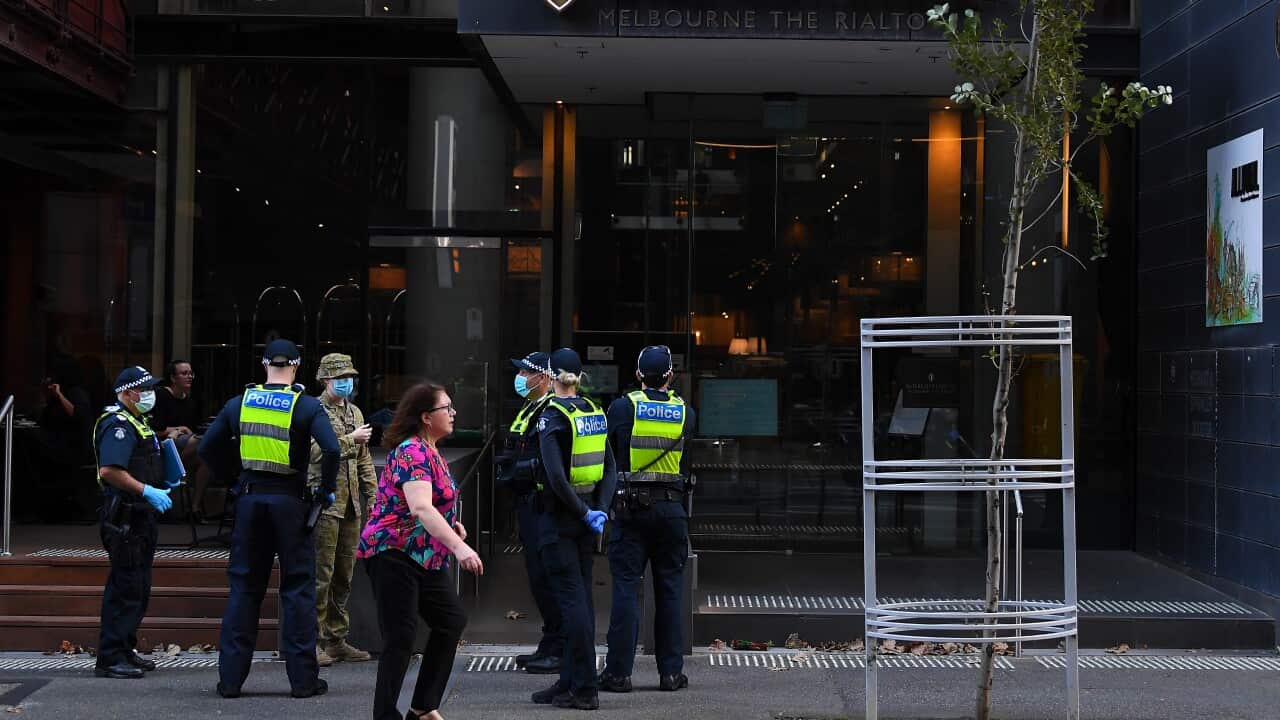 Victorian Police officers and Australian Defence personnel are outside of the Intercontinental quarantine hotel in Melbourne, Thursday, April 8, 2021. More than 100 returned travellers are set to arrive in Melbourne on Thursday