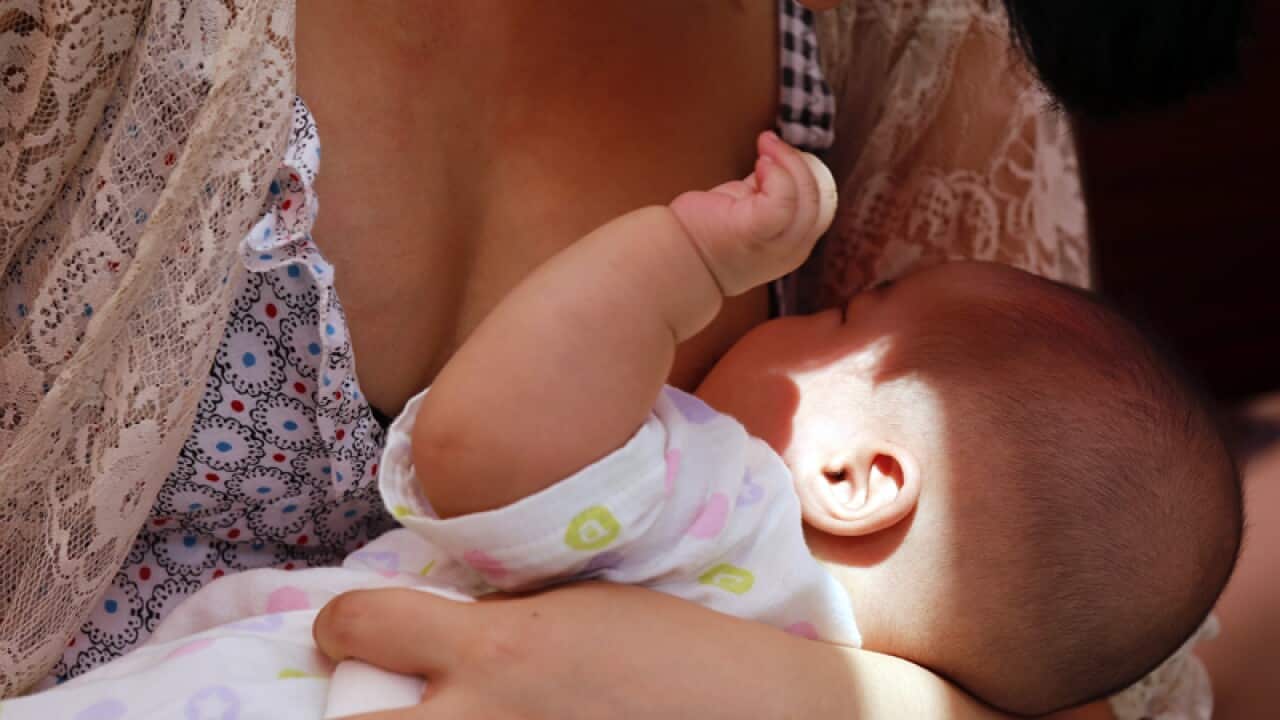 A Chinese mother breast-feeds her baby