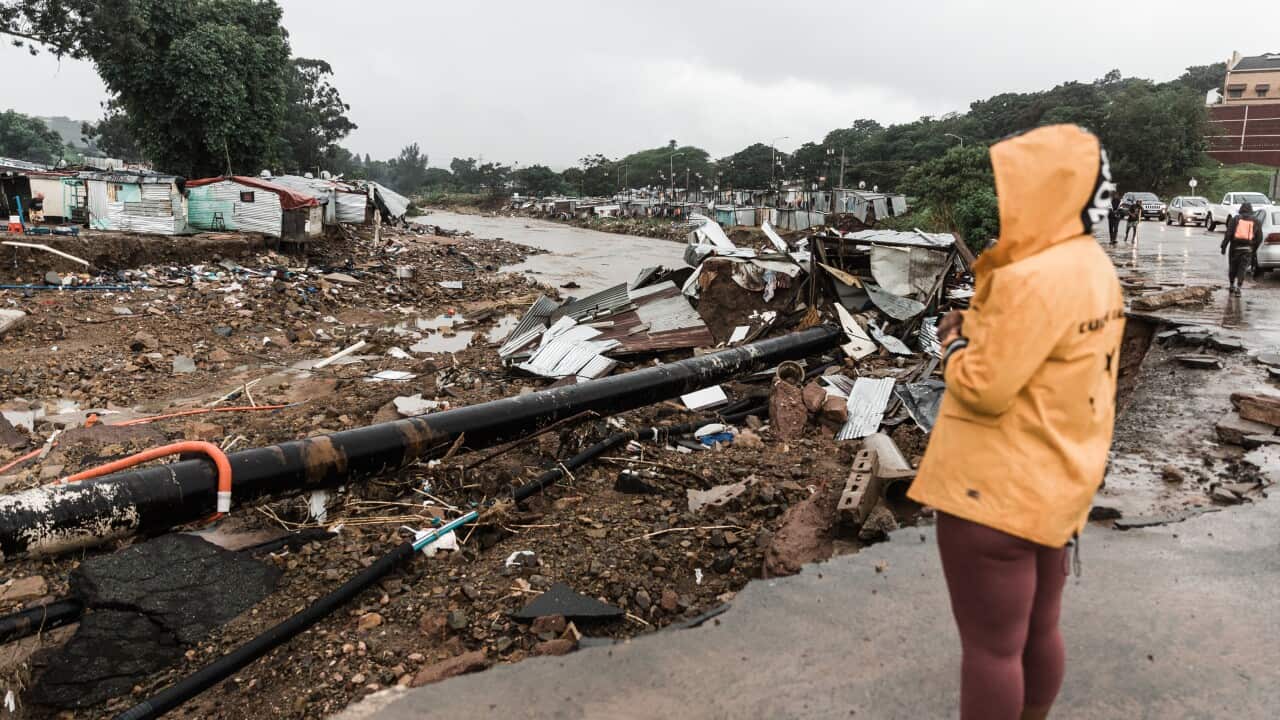 A woman looking at flood damage.