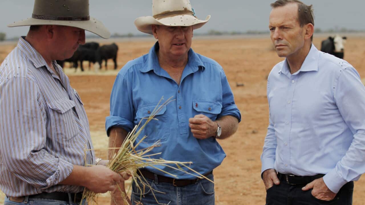 Tony Abbott (R) speaks with graziers in Bourke, NSW