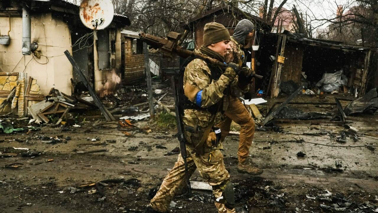 Ukranian soldiers inspect Bucha in Ukraine