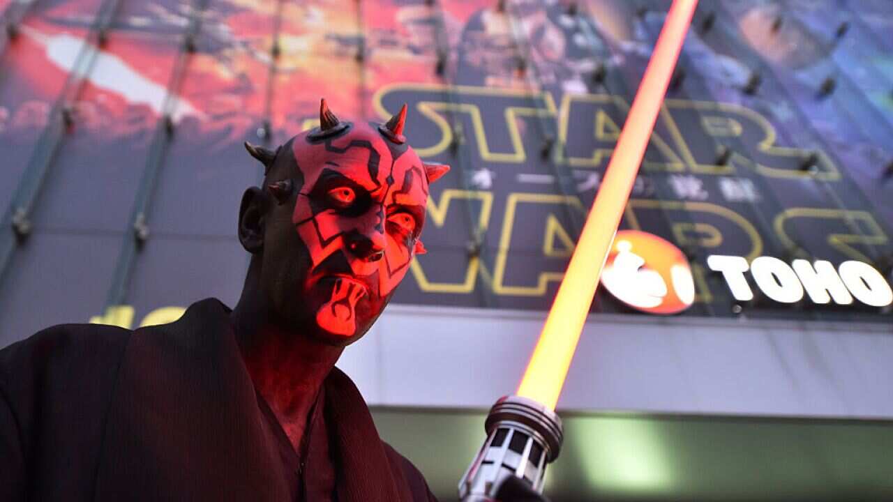 A fan dressed as a Star Wars character celebrates the opening of Star Wars: The Force Awakens in Tokyo 