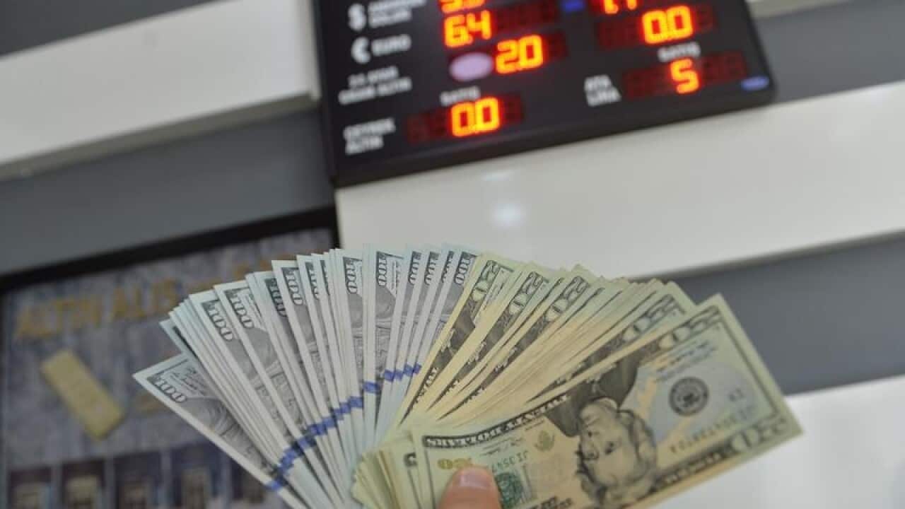 A money changer in Ankara counts Turkish lira notes