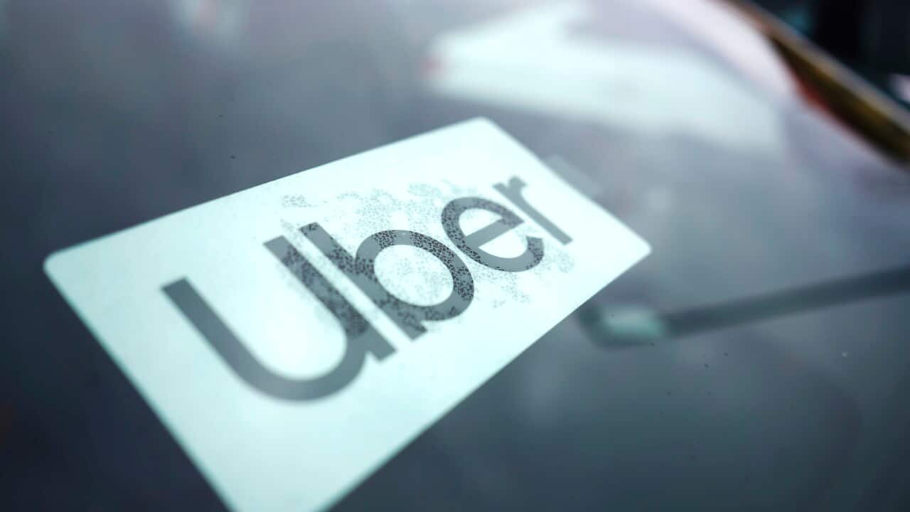 An Uber sticker on the windscreen of a car.