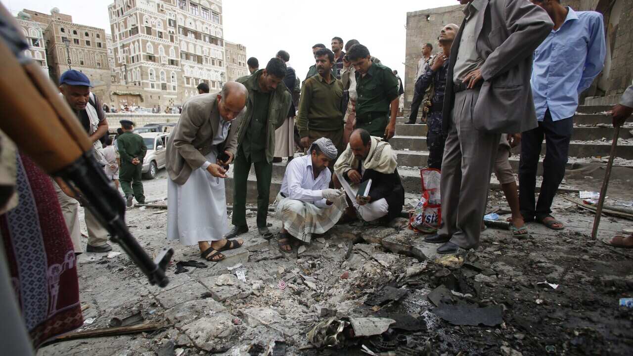 Yemenis inspect the site of an explosion near the old city of Sanaa. (AP Photo/Hani Mohammed)