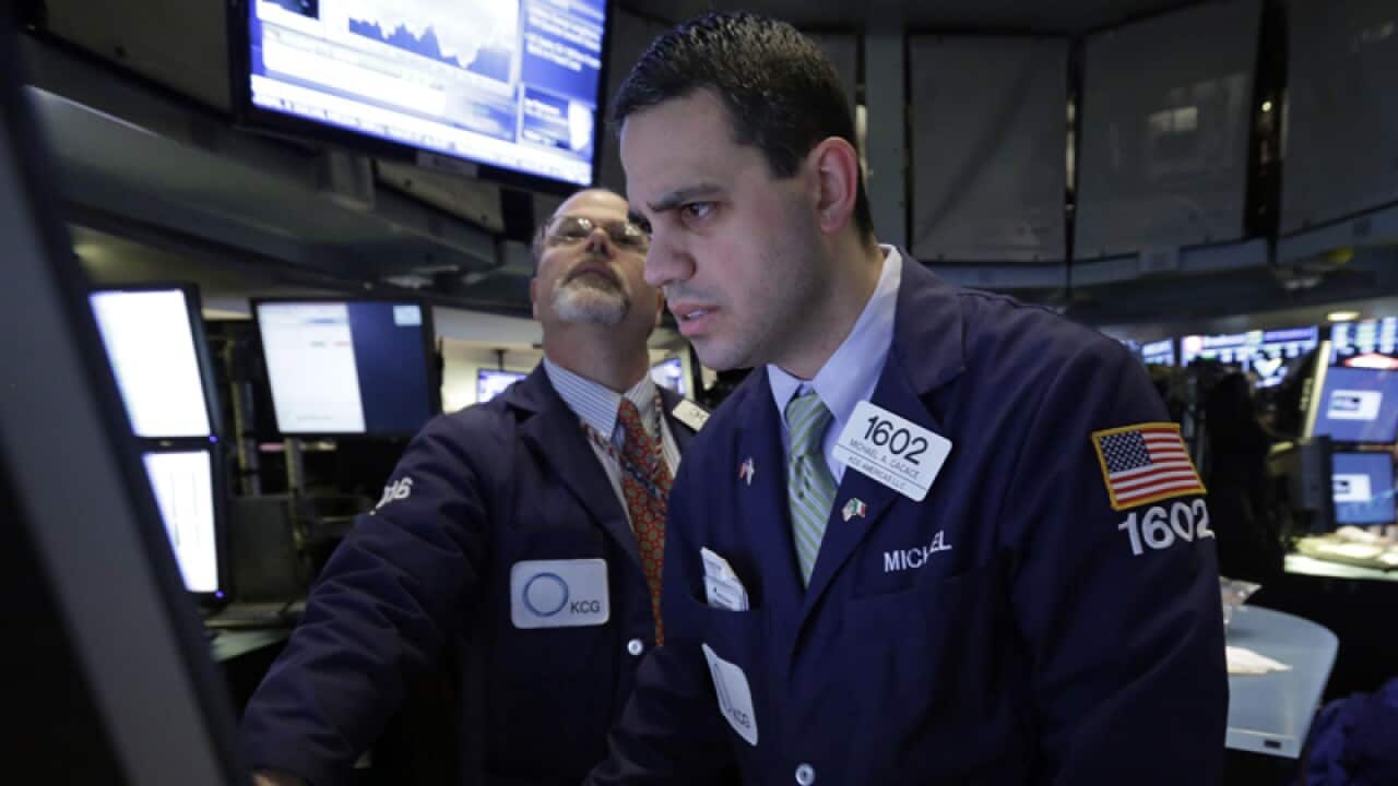 Traders work on the floor of the New York Stock Exchange