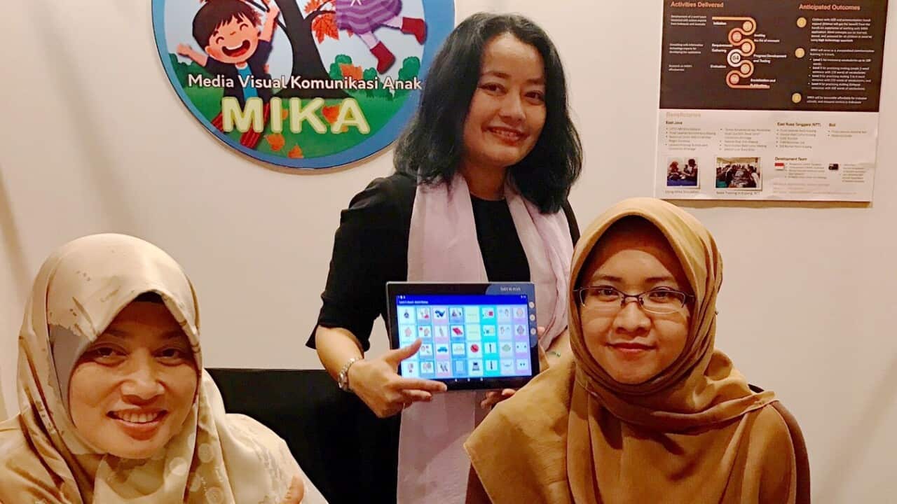 Margaretha (centre) and her team at the launch of  ‘Study App for children with autism (MIKA)’ at the Australian Alumni Dinner in 2019. (Supplied). 