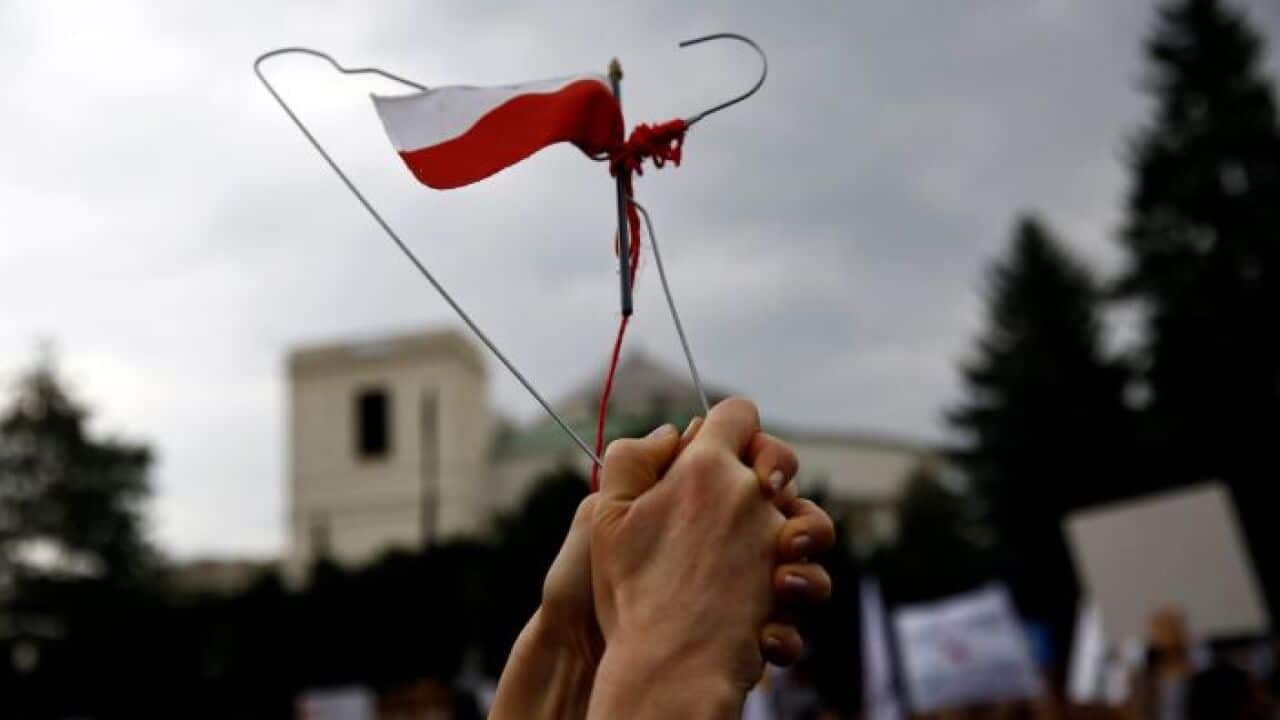 A coat hanger held up as a symbol of protest in Poland.