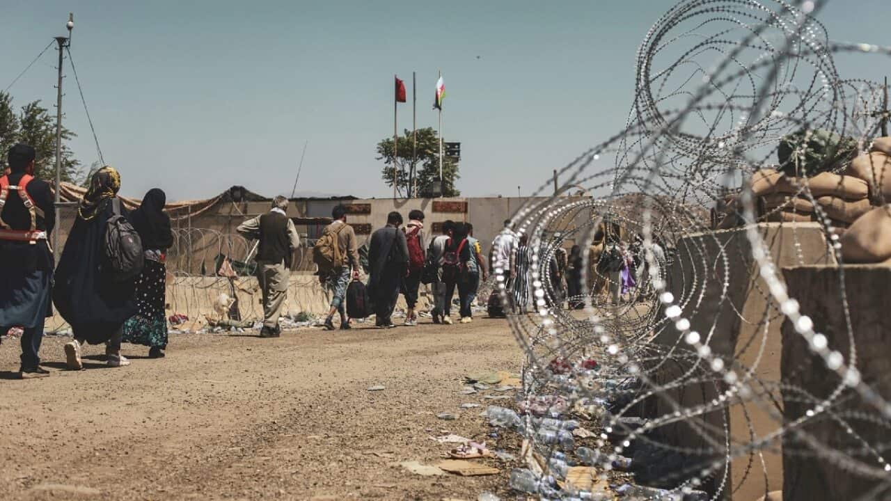 Evacuees wait to be processed at Hamid Karzai International Airport on 25 August 2021.