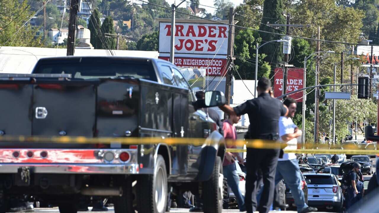 Police officers guard a supermarket with a barricaded suspect in Silverlake, Los Angeles.