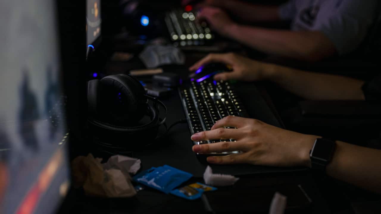 People in a video gaming centre in Shanghai, China, 31 August 2021.