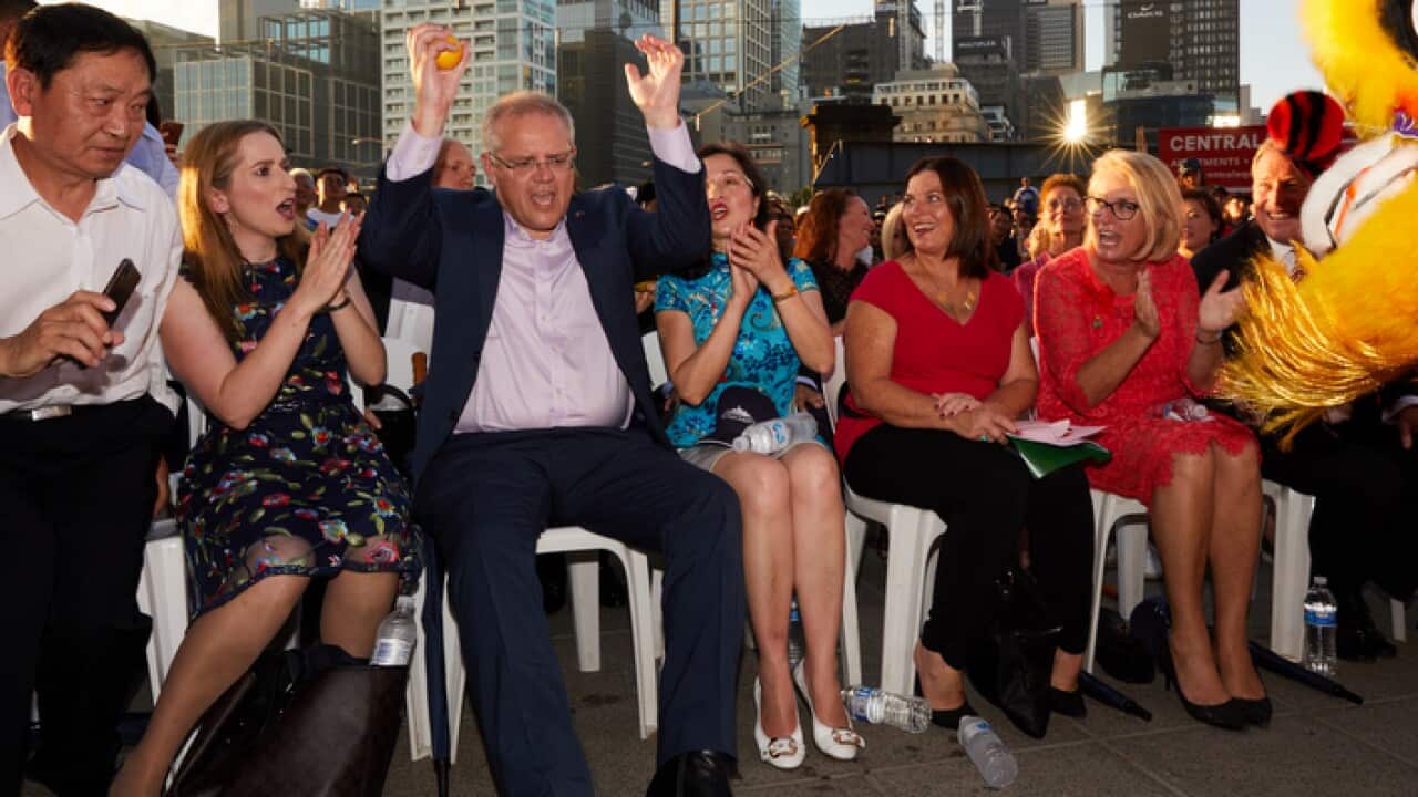 Prime Minister Scott Morrison reacts to a performance during the official opening of the Chinese New Year festival at Southbank in Melbourne, Saturday, February 2, 2019. (AAP Image/Erik Anderson) NO ARCHIVING