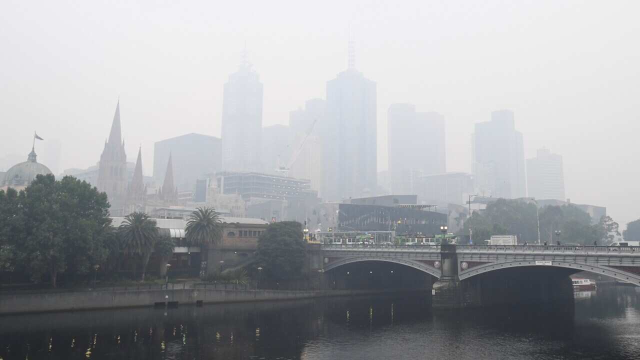 City buildings are seen through smoke haze from bushfires in Melbourne, Tuesday, January 14, 2020.