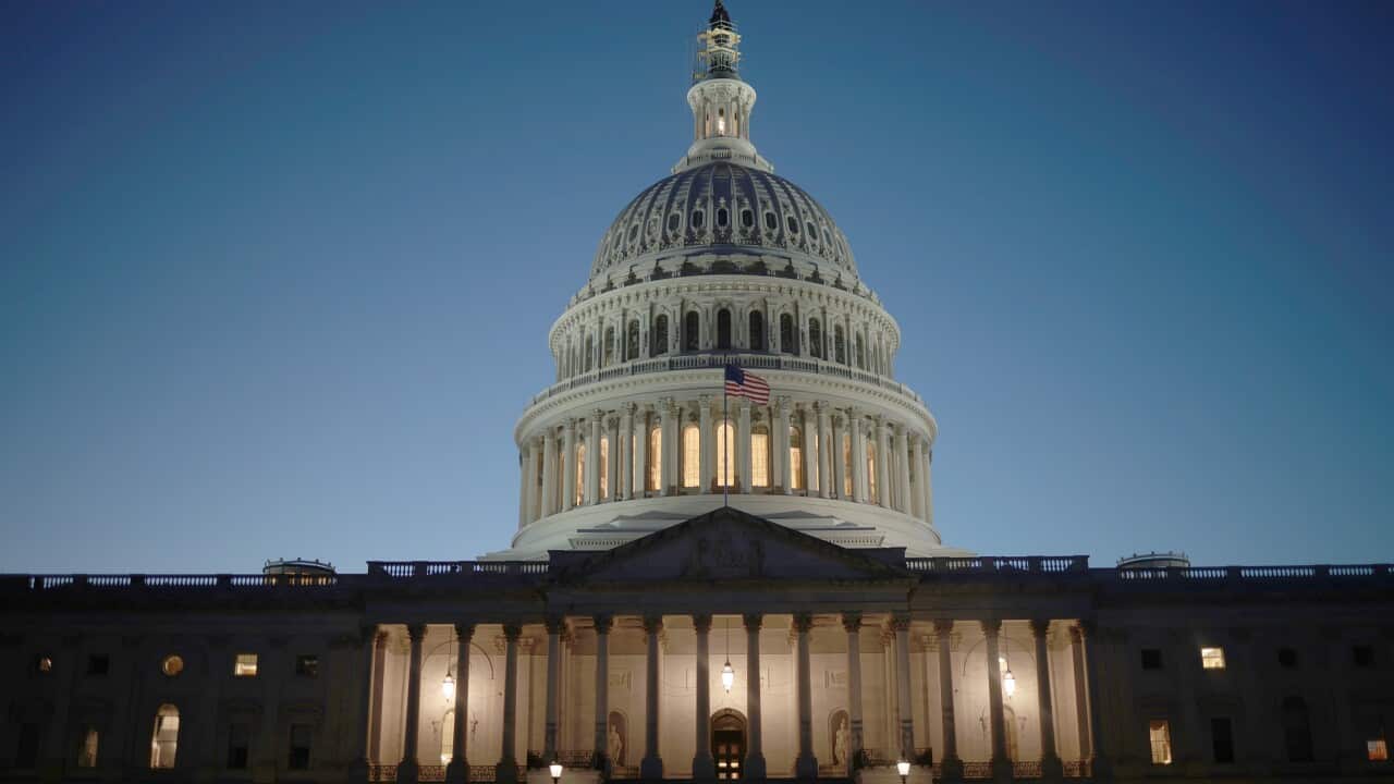 The US Capitol dome lit up at night.