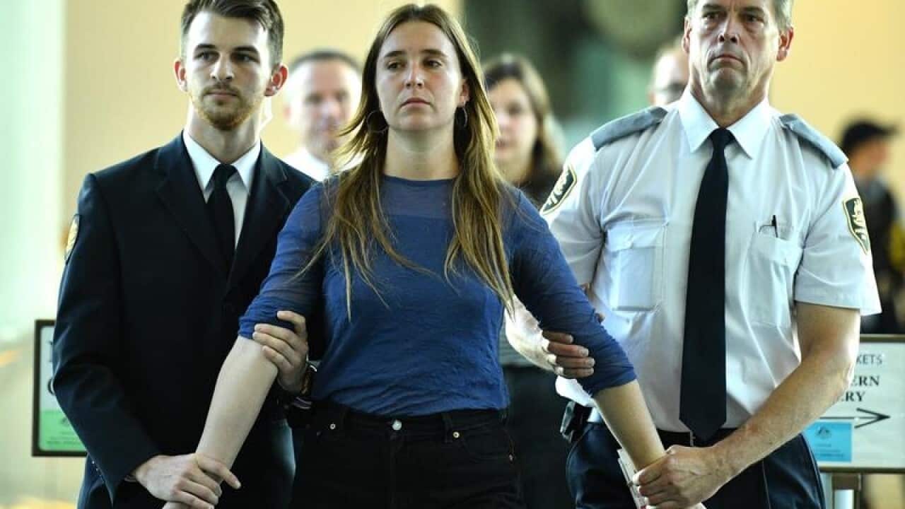 A protester is taken away from question time at Parliament House.