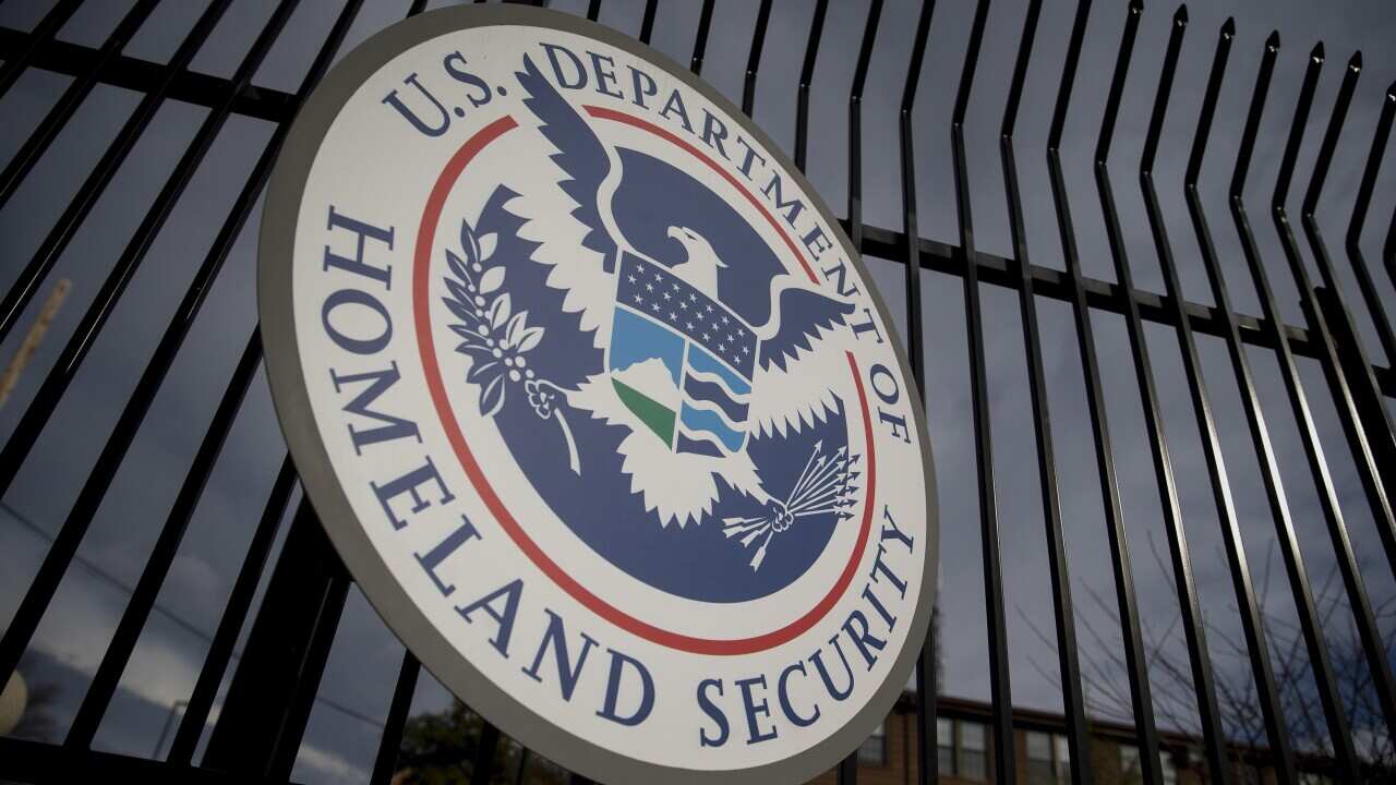 The US Department of Homeland Security (DHS) seal hangs on a fence at the headquarters in Washington DC