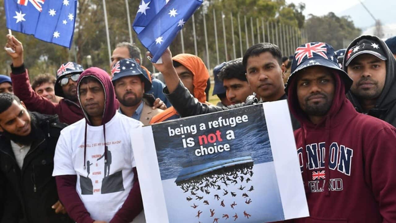 Temporary Protection Visa (TPV) and Safe Haven Enterprise Visa (SHEV) holders are seen as they attend a rally outside Parliament House in Canberra, July 2019