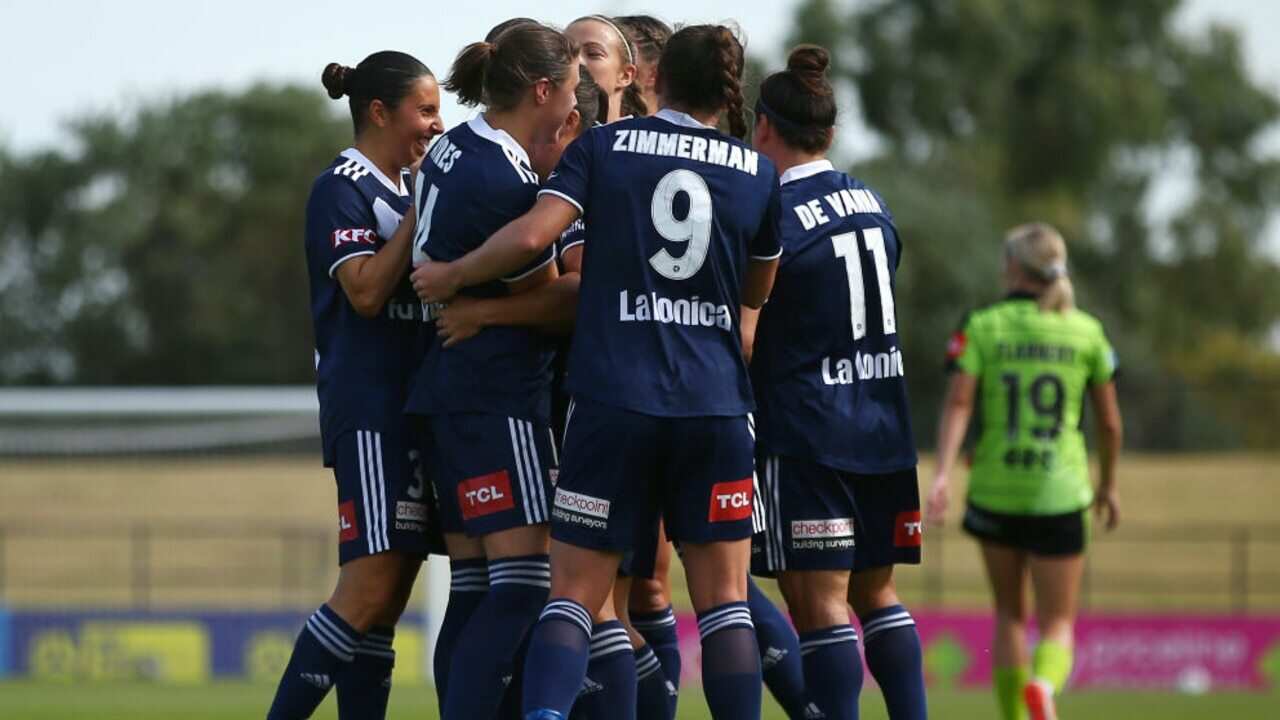 Angela Beard celebrates a goal with her Melbourne Victory teammates