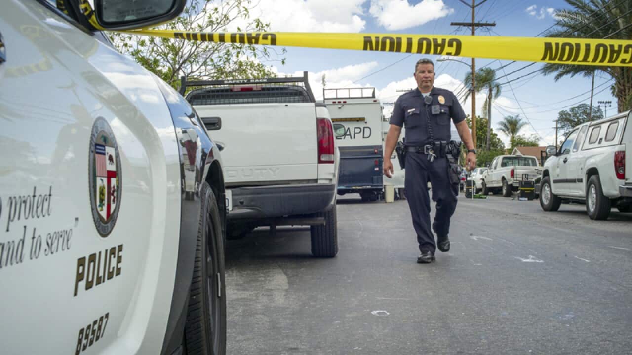 Police work the scene where a man was found shot to death