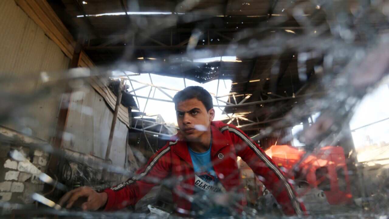 A Palestinian youth after an Israeli missile strike in Gaza Strip