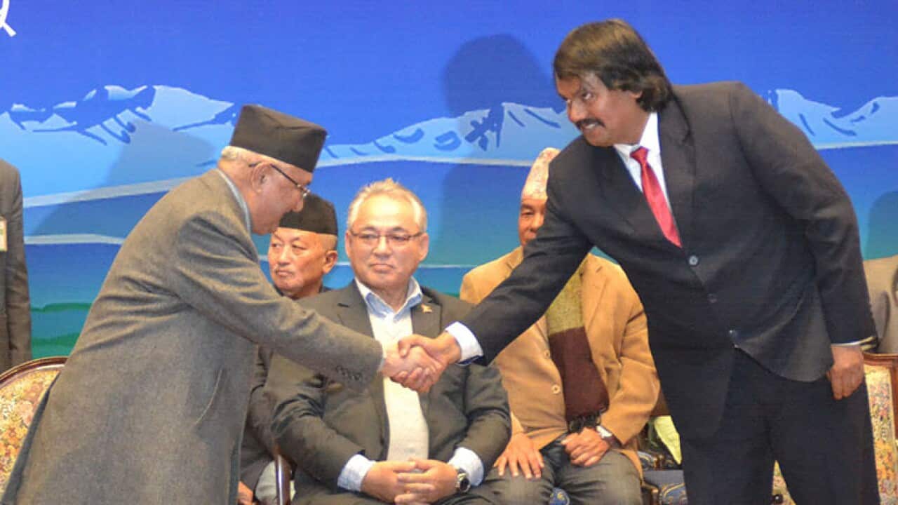 Nepal's Prime Minister KP Sharma Oli and Madhesh campaigner CK Raut shake hands after a 11 point agreement bringing Mr Raut to mainstream politics in Kathmandu.