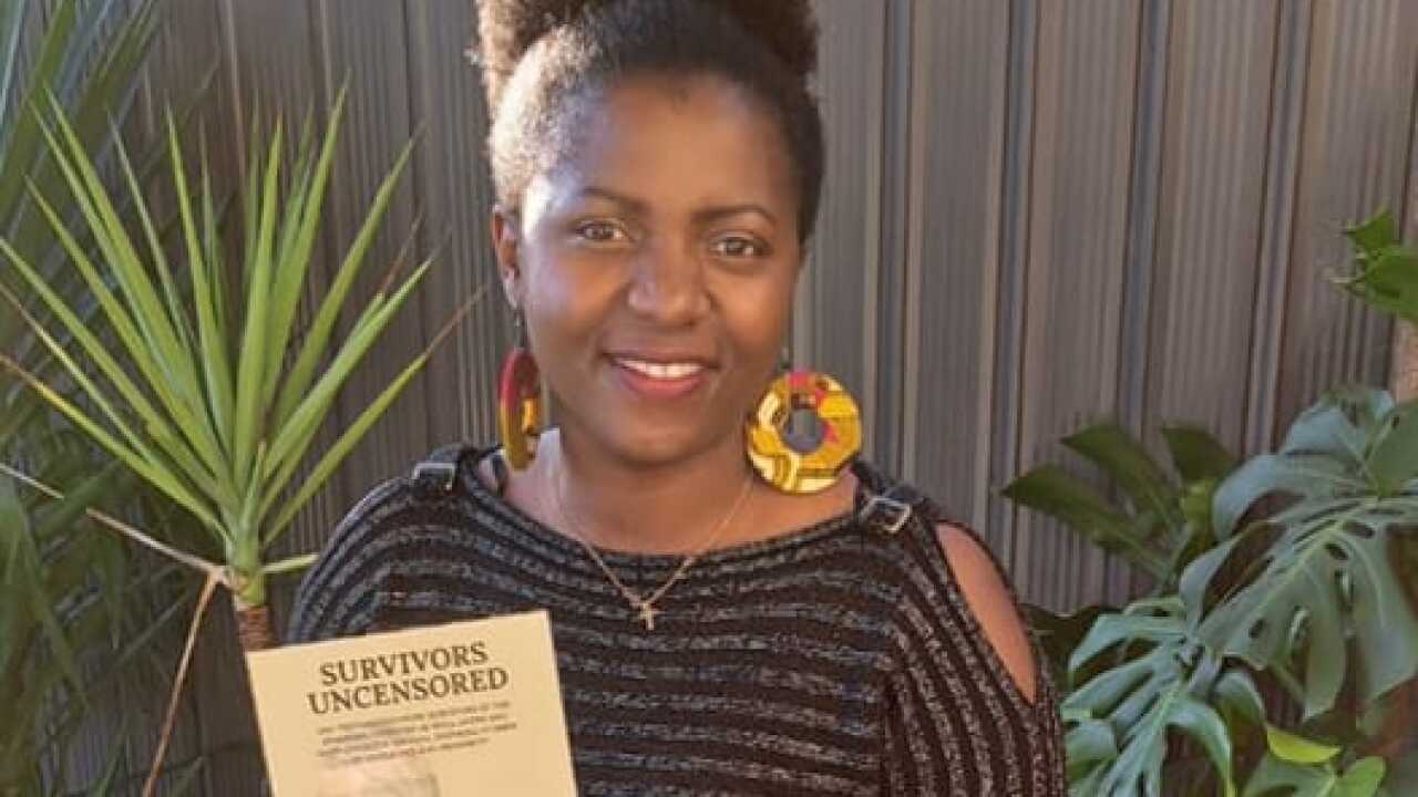 Bi Delphin akiwa na kitabu alicho changia kuandika.jpg