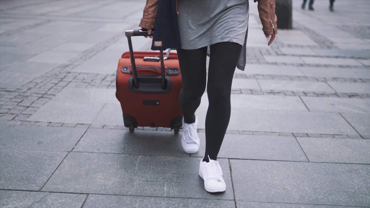 girl-tourist-walking-with-baggage-on-the-street-SBI-350960182.jpg