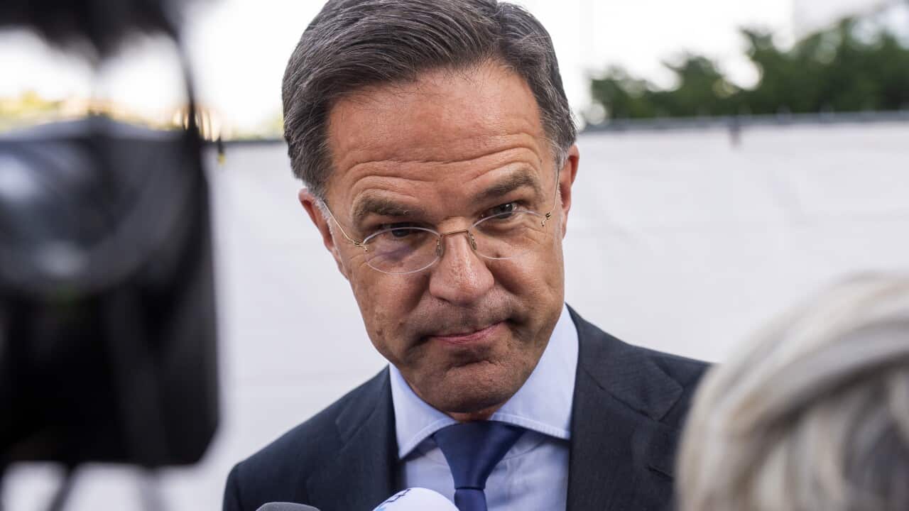 A man in a suit wearing glasses