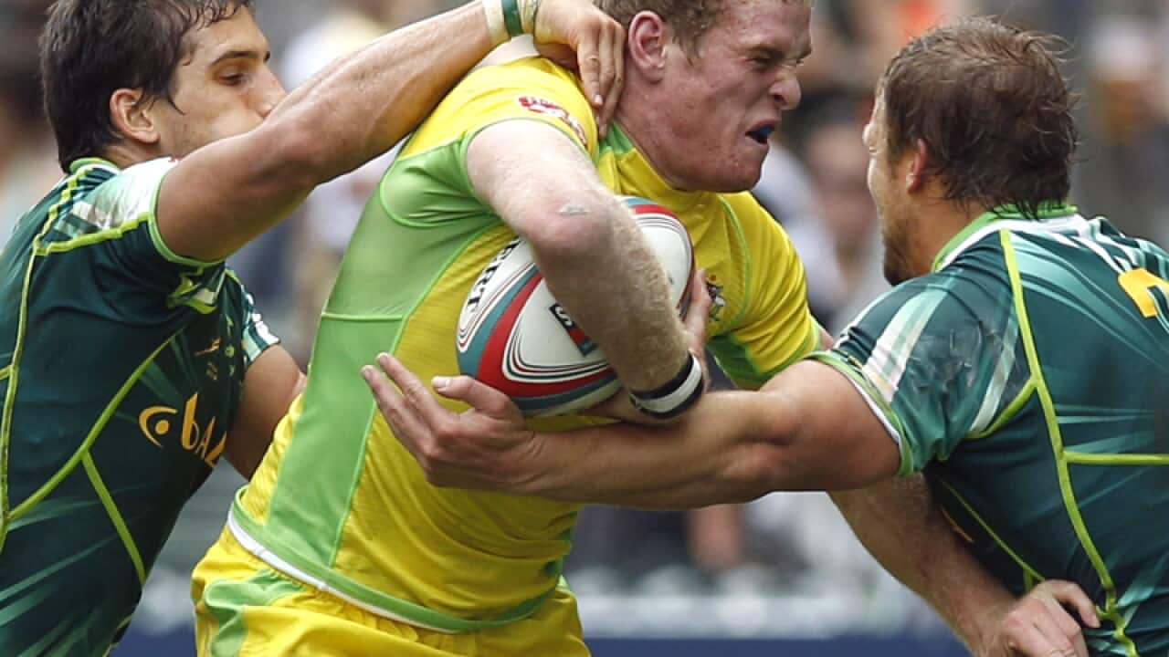 Tom Cusack of Australia (C) in action against South Africa
