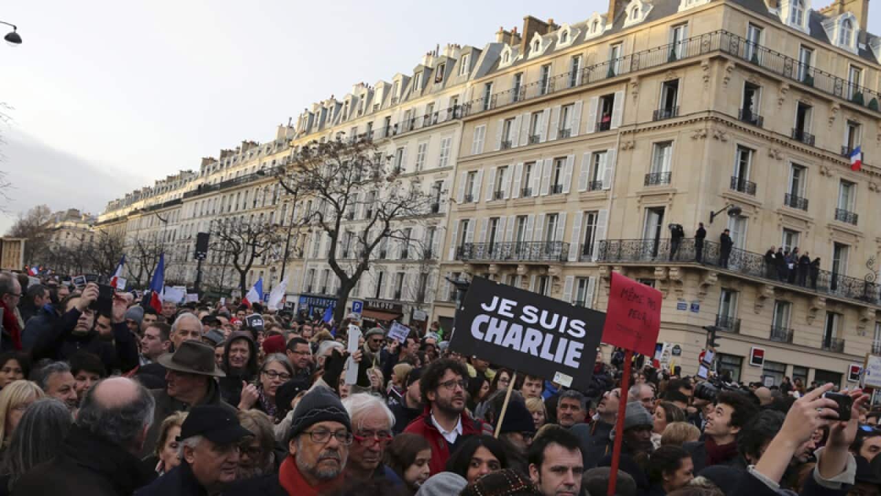 Thousands of people wave national flags