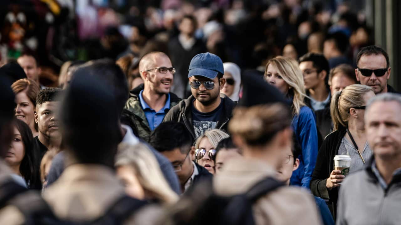 An image showing a crowd of people in a city.