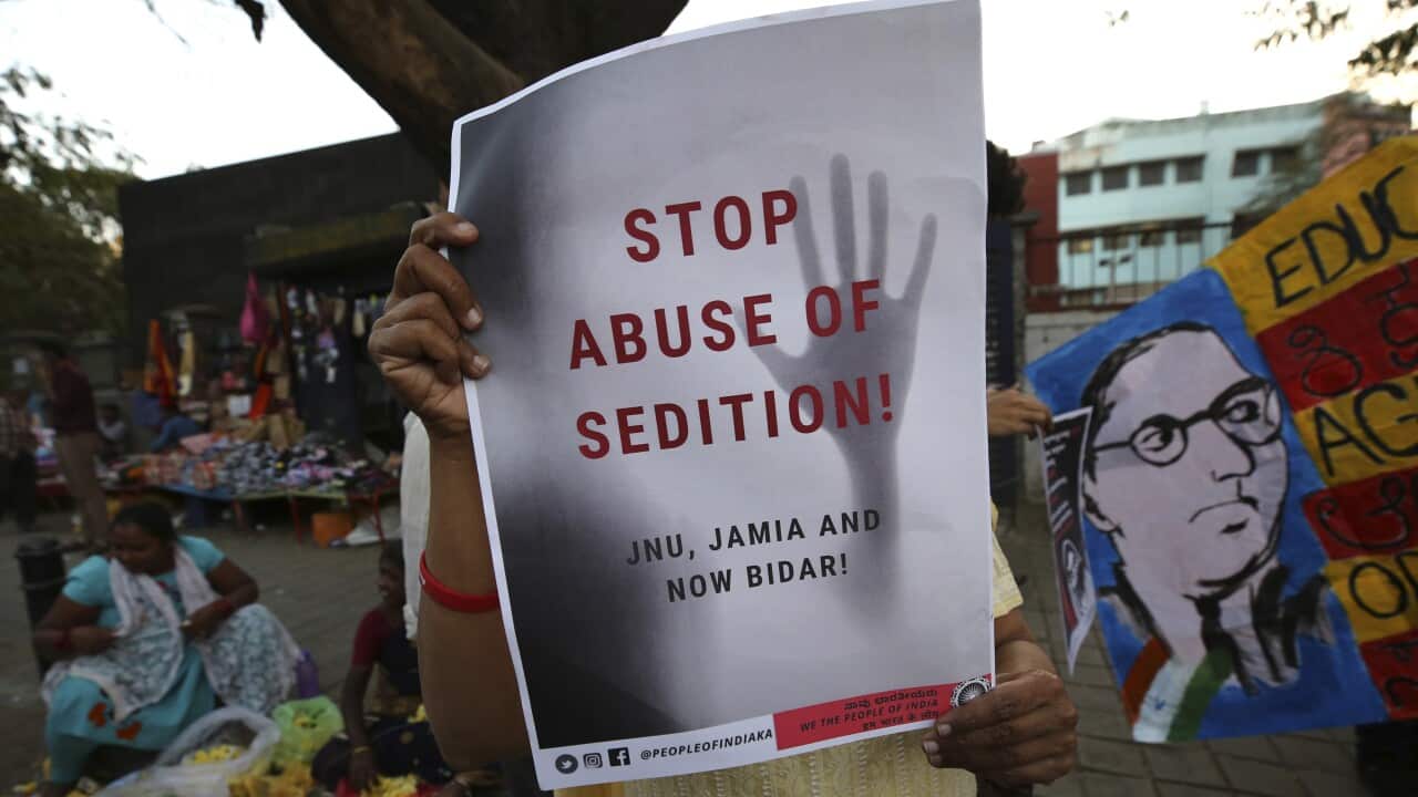 A woman holds a placard protesting against the sedition case filed by police against a school after a play performed by students denouncing a new citizenship law, in Bangalore, India, Tuesday, Feb. 4, 2020.