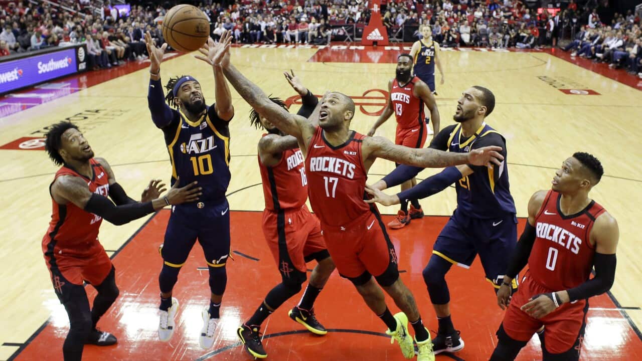 Utah Jazz guard Mike Conley (10) and Houston Rockets forward P.J. Tucker (17) vie for a rebound. Chinese state television has stopped screening the NBA.