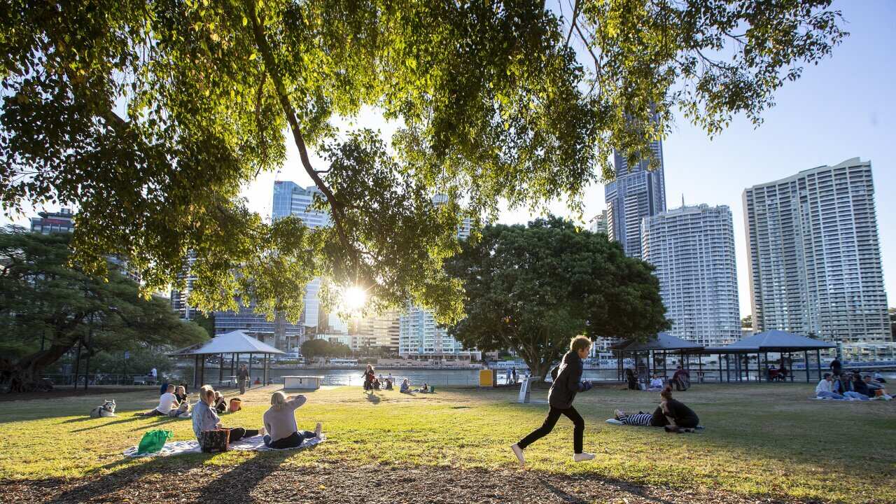 Queenslanders are being urged to continue practicing social distancing as some coronavirus measures are rolled back.
