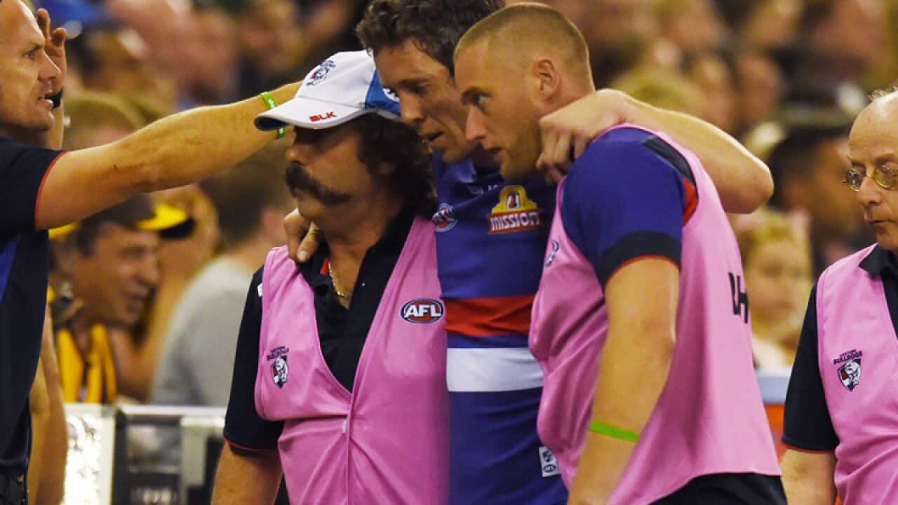 Western Bulldogs captain Rob Murphy is taken from the field
