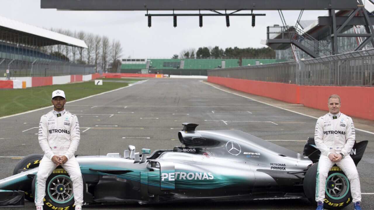 Mercedes F1 drivers Lewis Hamilton (L) and Valtteri Bottas