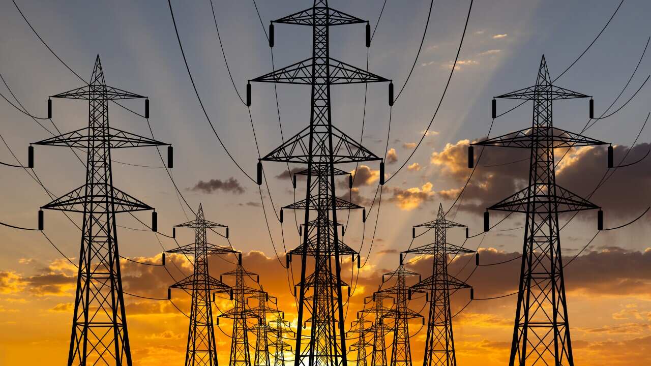 High voltage towers at sunset background. Power lines against the sky