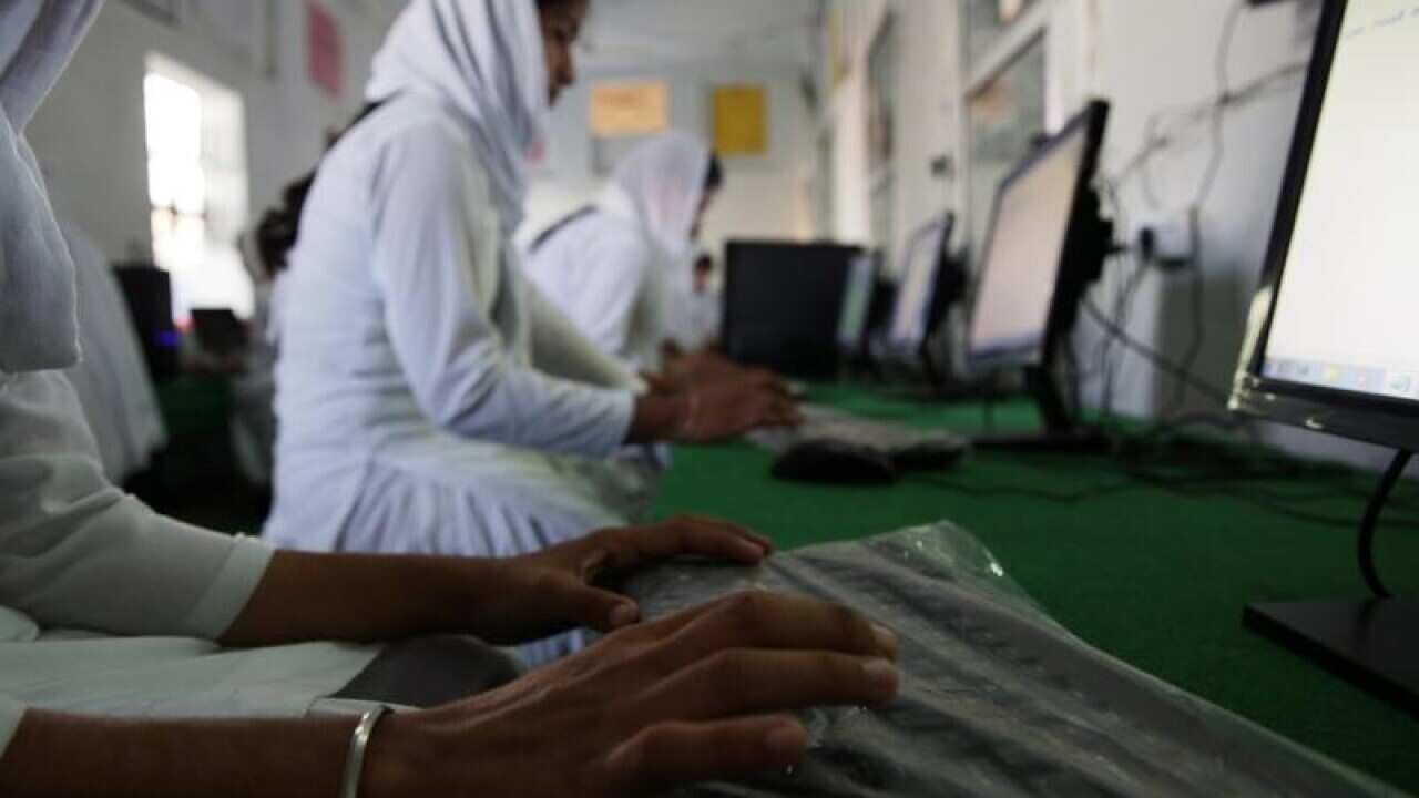 Students study in computer class at a girls college in India
