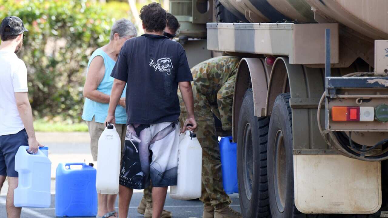 Locals collect drinking water from an army tanker in Airlie Beach
