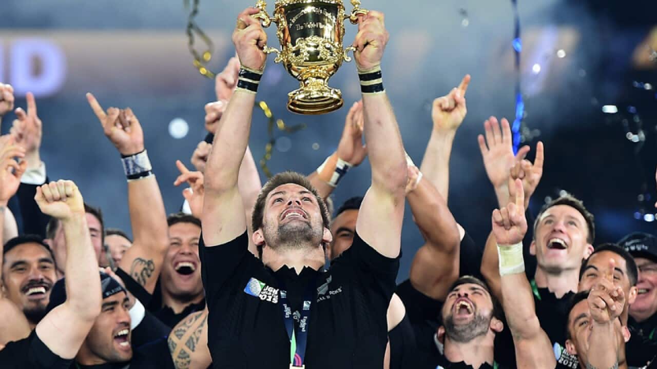 New Zealand's captain Richie McCaw lifts the Webb Ellis Trophy