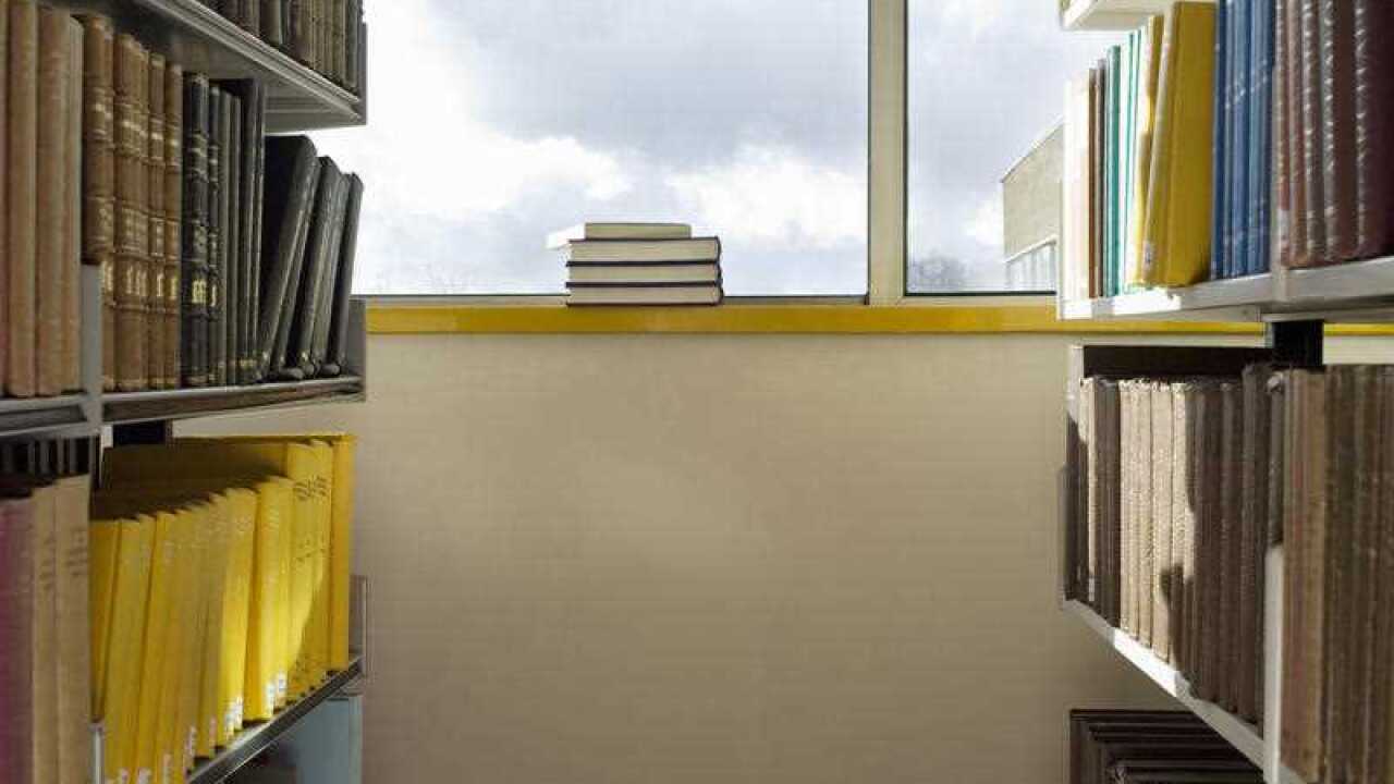 Library interior pile of books on windowsill