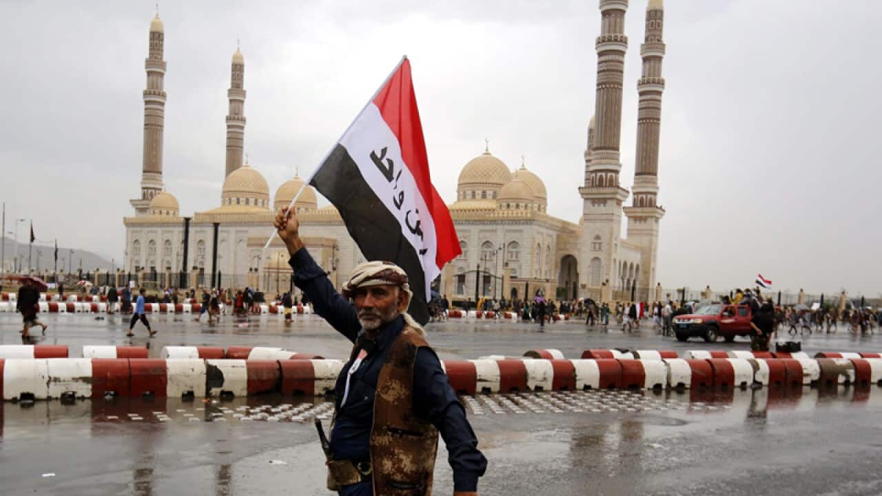 A Yemeni waves a national flag