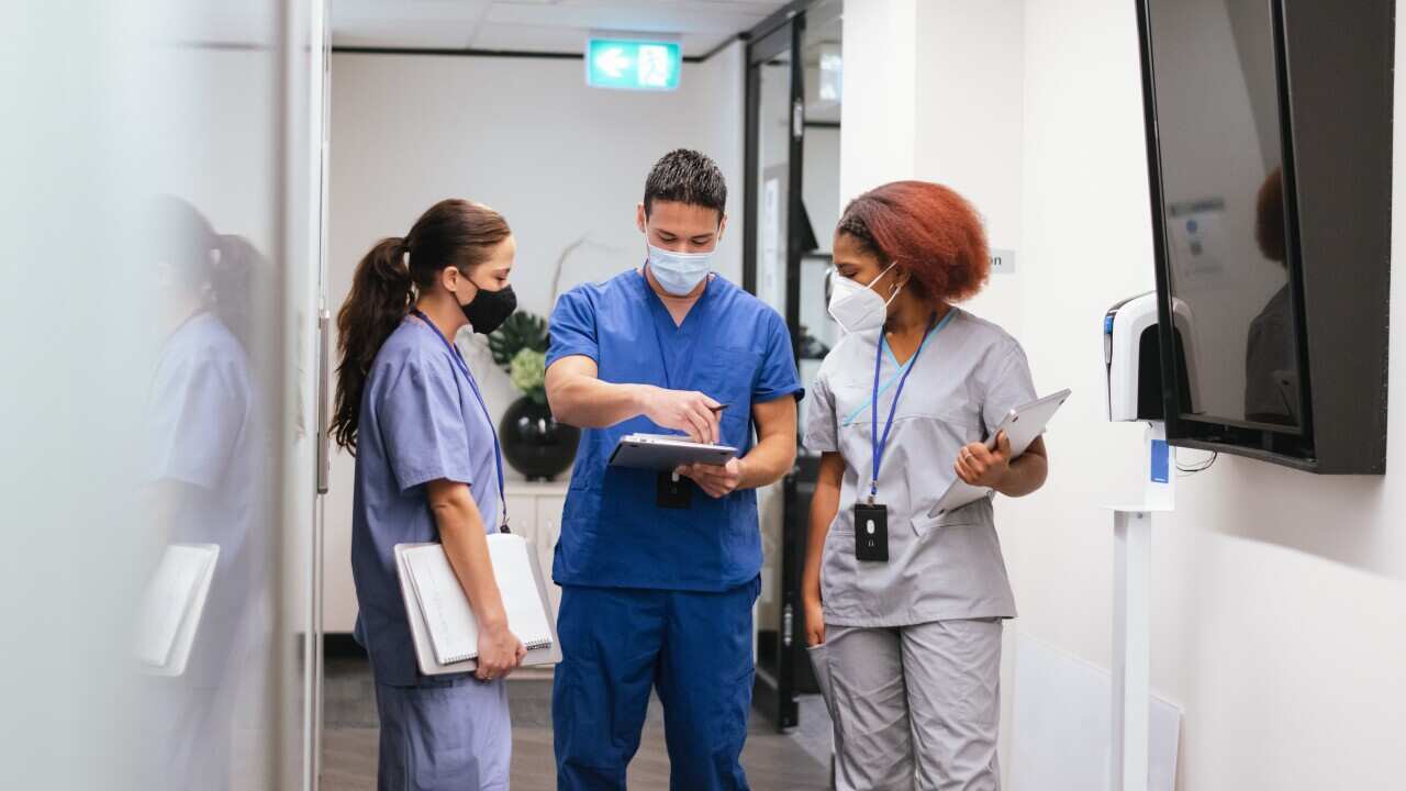 Nurses gather in hospital hallway during pandemic